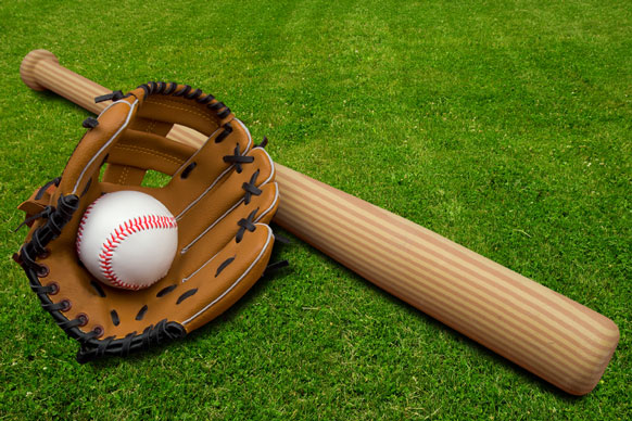baseball glove, ball, and bat on a baseball field
